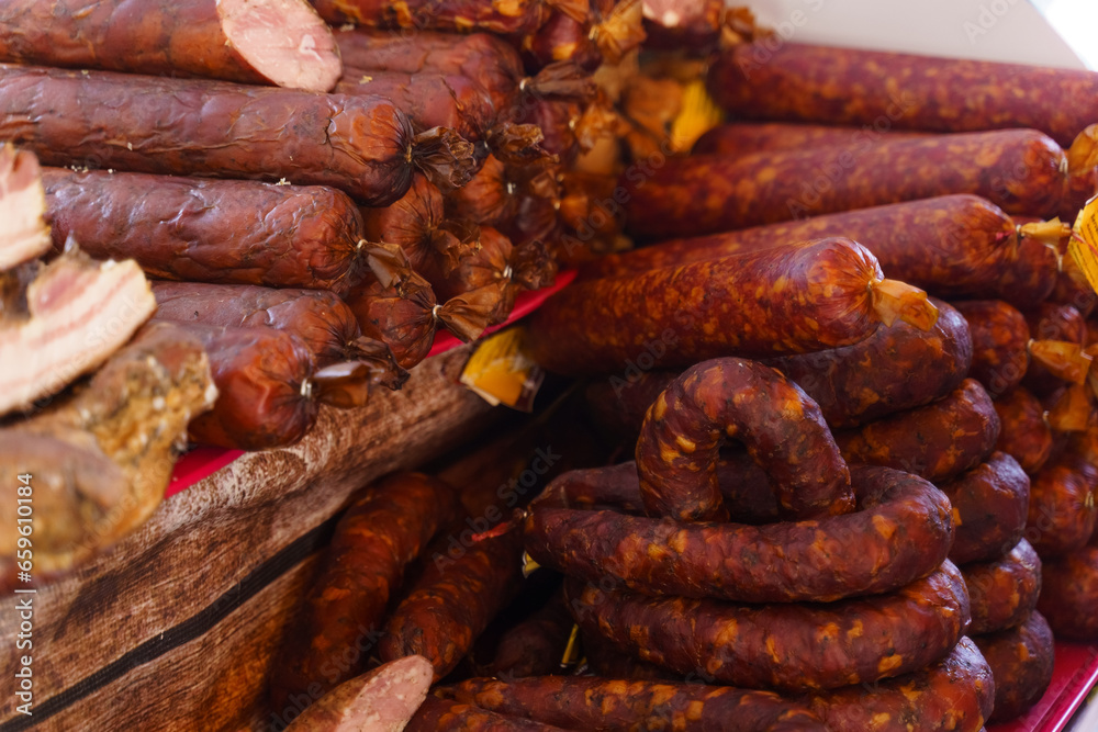 Fototapeta premium There are raw smoked sausages on the market.