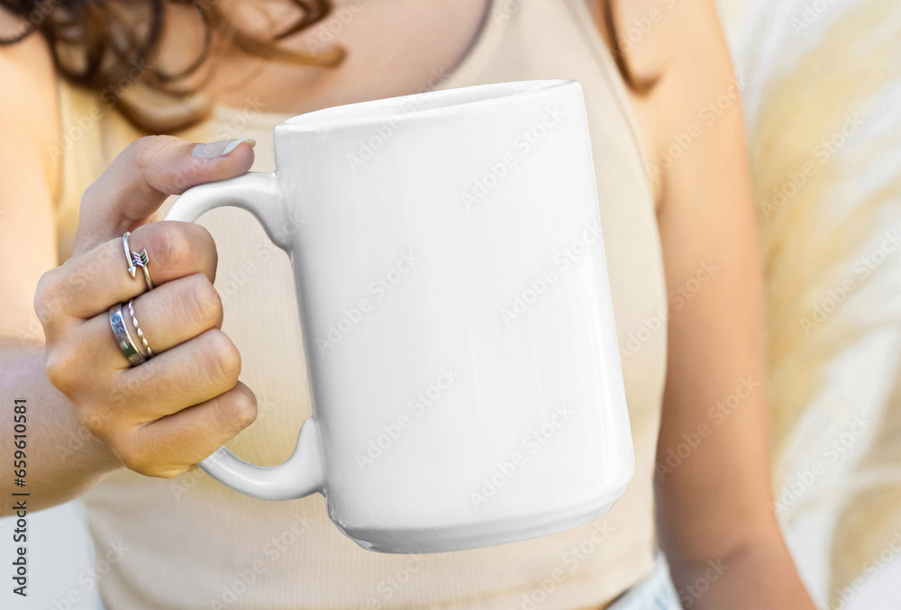 Girl is holding white mug in hands. Blank 15 oz ceramic cup Girl is holding white mug in hands. Blank 15 oz ceramic cup
