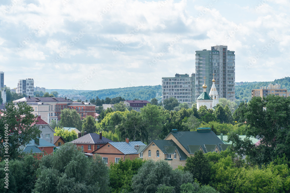 Cityscape of a green residential area with buildings in the city of Cheboksary, Russia