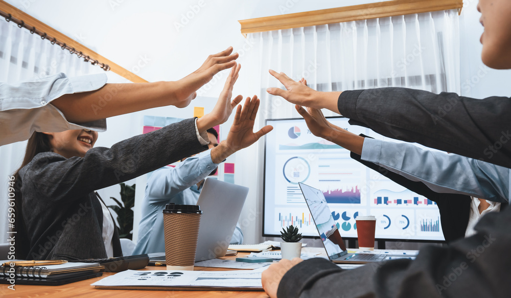 Diverse business team celebrate successful meeting with high-fives and expressions of happiness in corporate office meeting represent unity success and professional integrity. Concord - obrazy, fototapety, plakaty 