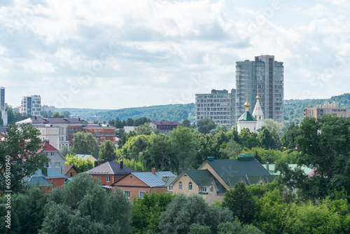 Cityscape of a green residential area with buildings in the city of Cheboksary, Russia © Anna