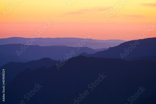 Picturesque golden pink sunset in the mountains. Shooting on a long lens. Copy space. © ROMAN DZIUBALO