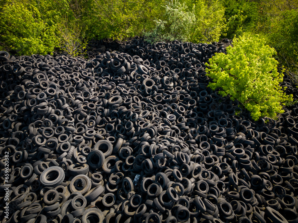 Aerial view of the stark contrast between a massive landfill of used