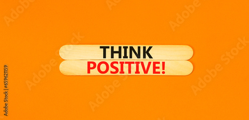 Think positive symbol. Concept words Think positive on wooden stick. Beautiful orange table orange background. Business, motivational think positive thinking concept. Copy space.