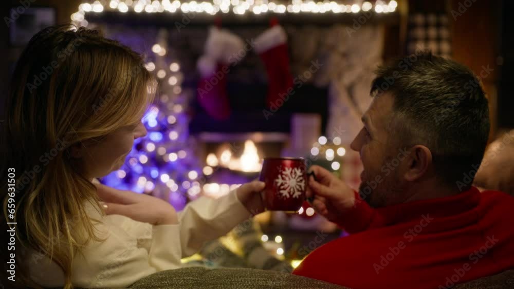 Boyfriend and girlfriend enjoying hot drink and conversation on Christmas holiday vacation closeup. Romantic couple embrace cuddle on winter vacation. Two lovers enjoying cozy fireplace back view 4k Boyfriend and girlfriend enjoying hot drink and conversation on Christmas holiday vacation closeup. Romantic couple embrace cuddle on winter vacation. Two lovers enjoying cozy fireplace back view 4k