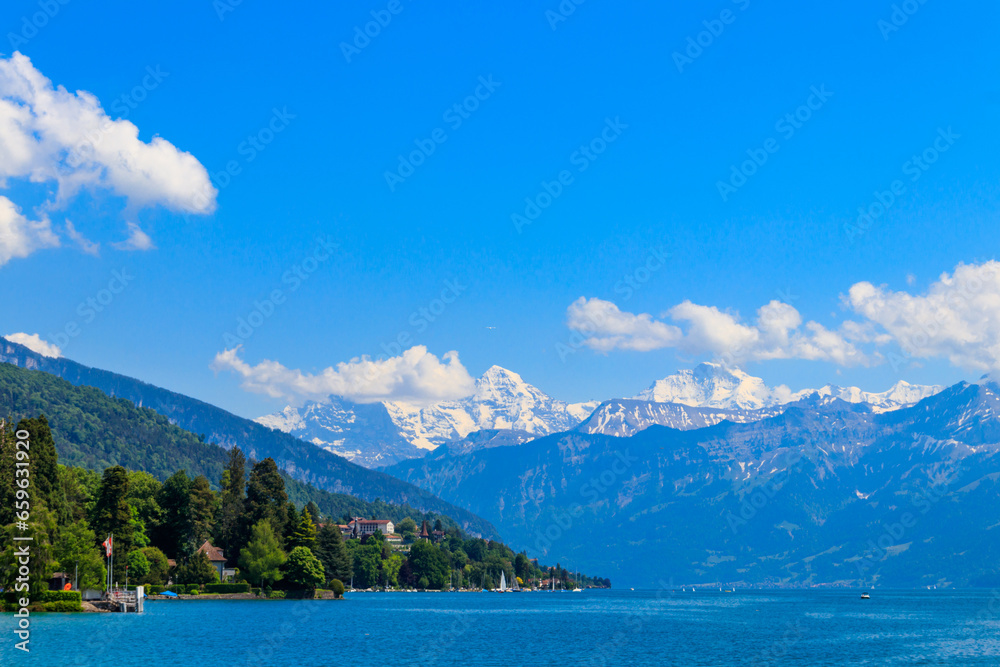 View of the Annecy lake surrounded by beautiful mountains in Annecy, France View of the Annecy lake surrounded by beautiful mountains in Annecy, France