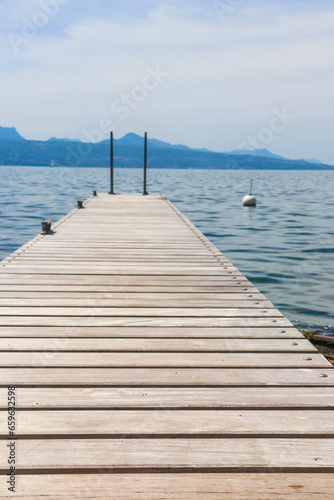 Wooden pier overlooking the Alps and Lake Geneva in Switzerland © olyasolodenko