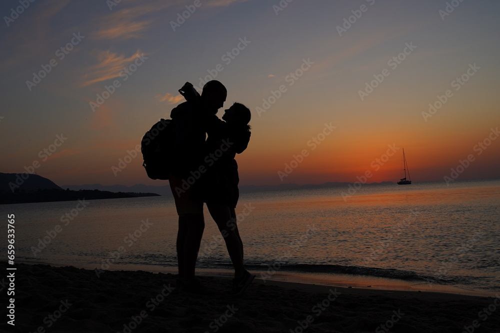 Couple Embracing at Sunrise by the Sea