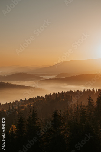 Fototapeta Naklejka Na Ścianę i Meble -  As the first light of dawn gently kisses the horizon, the mountains awaken in a symphony of natural beauty.