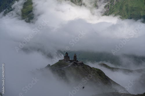 A view of the iconic Trinity Church in Stepantsminda surrounded by low clouds © Ashraf