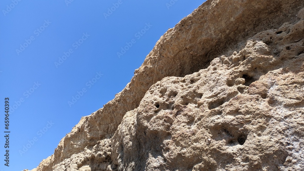 A canopy made of stone is a natural phenomenon standing hanging over the beach in Lisbon, an unusual phenomenon