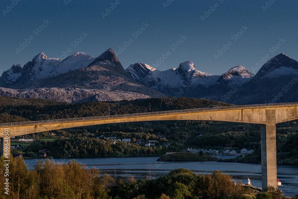 Norwegian Landscape: Bridge Over a River Amidst Majestic Mountains