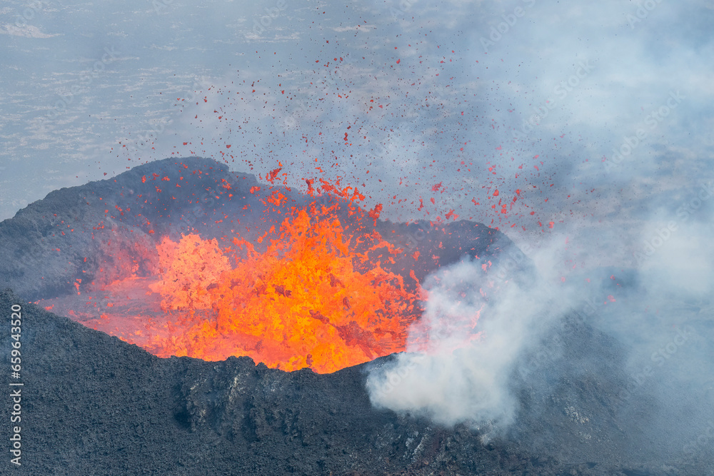 Close up view of lava splashing high and all directions in spatter cone of fissure near Litli-Hrútur Hill during the 2023 eruption near the mountain Fagradalsfjall, Iceland volcano area 