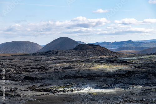 Panoramic view over lavafield near mountain Fagradalsfjall with fissure vent of 2021 in Geldingadalir volcano area to the south of Fagradalsfjall mountain, Iceland