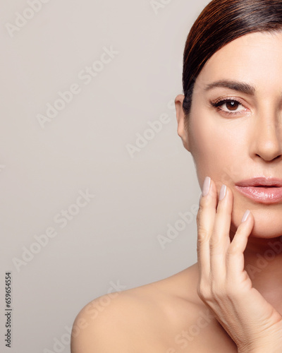 Glowing and youthful woman with moisturized skin in relaxing spa treatment. With copyspace.
