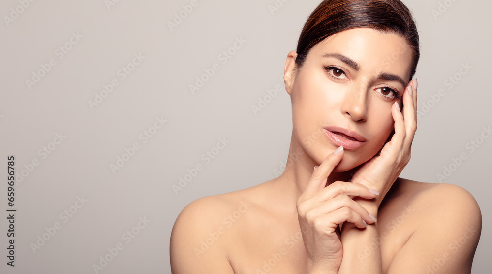 Serene beauty: Calm and confident young adult woman with glowing, moisturized skin for rejuvenating spa treatment. With copyspace.