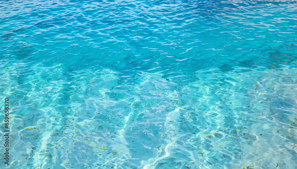 Blue ripped sea water as swimming pool. Crystal clear ocean lagoon bay turquoise blue azure water surface, closeup natural environment. Tropical Mediterranean beach water background