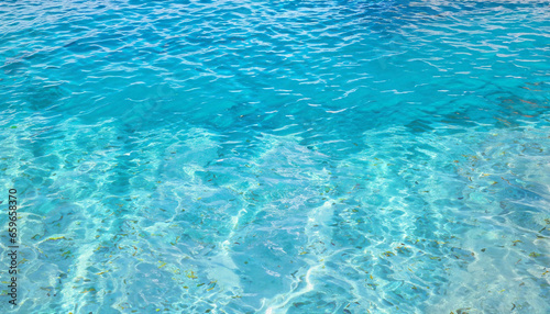 Blue ripped sea water as swimming pool. Crystal clear ocean lagoon bay turquoise blue azure water surface, closeup natural environment. Tropical Mediterranean beach water background