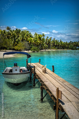Tranquil Coastal Beauty: Sunlit Bay and Boat on Nature's Rangaria, French Polynesia