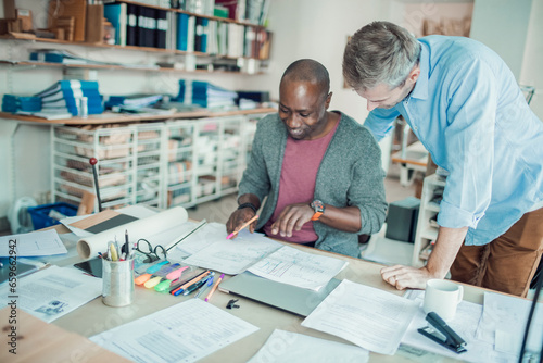 Two male architects working on a project together in a modern office