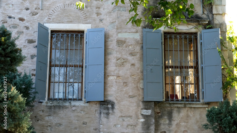 A beautiful window detail with blue shutters