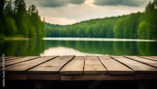 A wooden tabletop that is empty, with a summer lake and green forest in the distance.