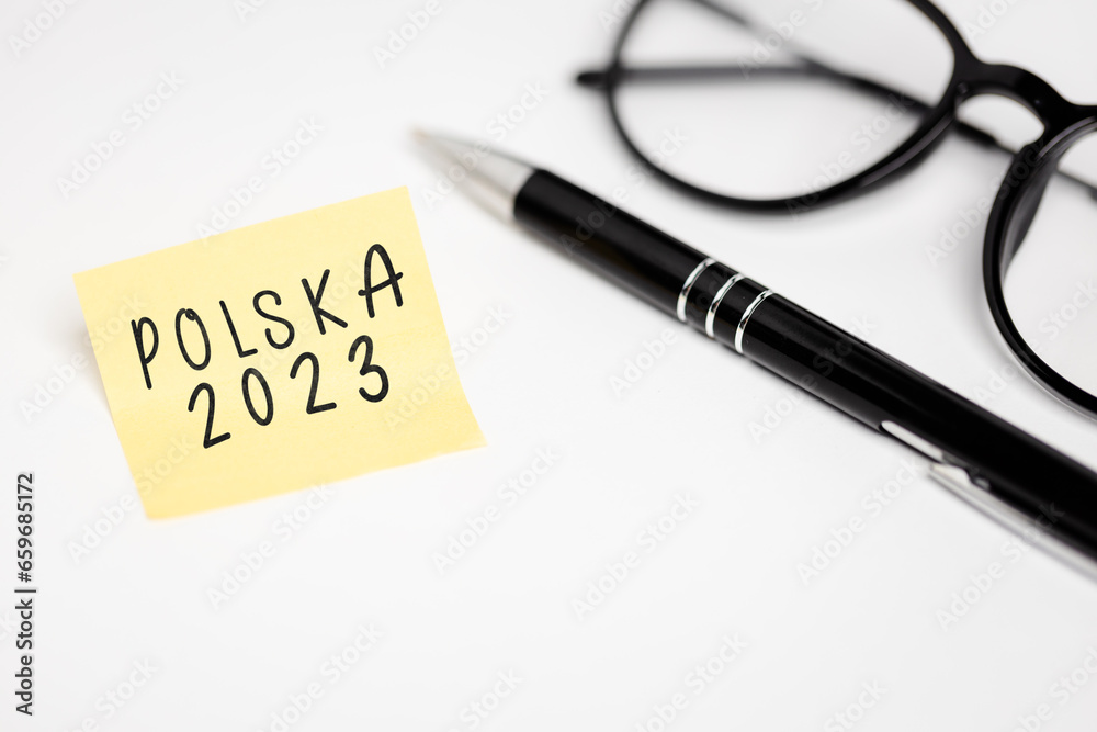 a yellow piece of paper stuck to a white table with the inscription 