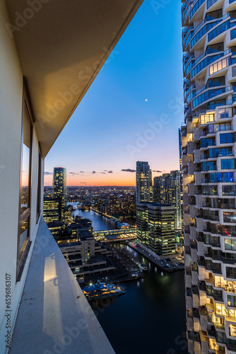 view of the financial district in London with reflections in a window of a residential building