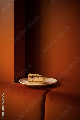 A piece of cheesecake on red background at the restaurant 
