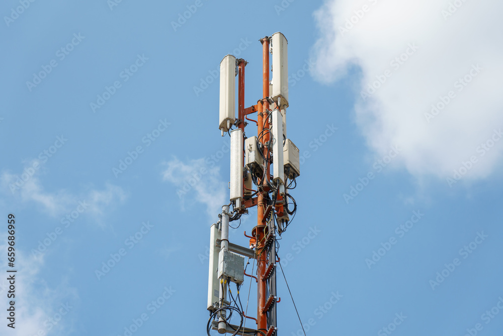 New GSM antennas on a high tower against a blue sky for transmitting a 5g signal are dangerous to health. Radiation pollution of the environment through cell towers. The threat of extinction New GSM antennas on a high tower against a blue sky for transmitting a 5g signal are dangerous to health. Radiation pollution of the environment through cell towers. The threat of extinction