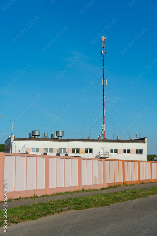 New GSM antennas on a high tower against a blue sky for transmitting a 5g signal are dangerous to health. Radiation pollution of the environment through cell towers. The threat of extinction New GSM antennas on a high tower against a blue sky for transmitting a 5g signal are dangerous to health. Radiation pollution of the environment through cell towers. The threat of extinction