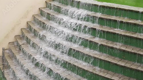 artificial waterfall fountain water falling. Beautiful water texture at park german forest, curitiba Paraná Brasil photo