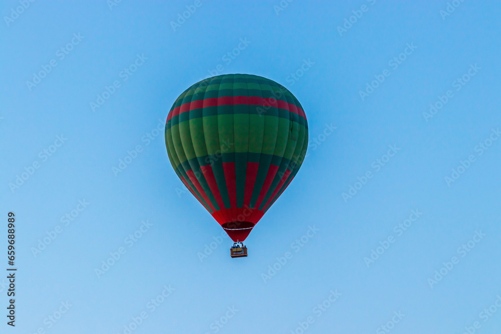 Hot balloon flying at sunset over the Atlas Mountains in the desert of Morocco Hot balloon flying at sunset over the Atlas Mountains in the desert of Morocco