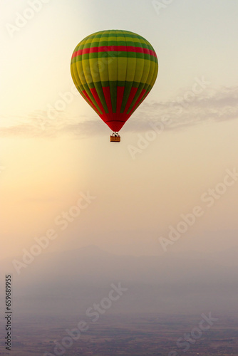 hot air balloon in the sky in Morocco flying over the atlas mountain at sunset