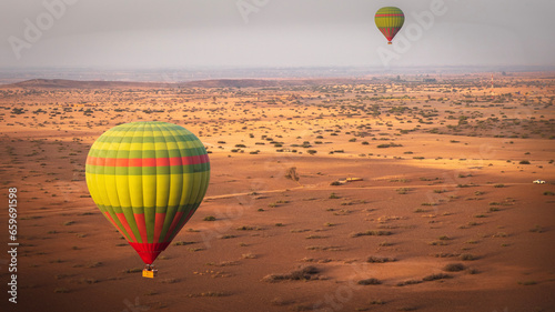 hot air balloon over the Moroccan desert and Atlas Mountains