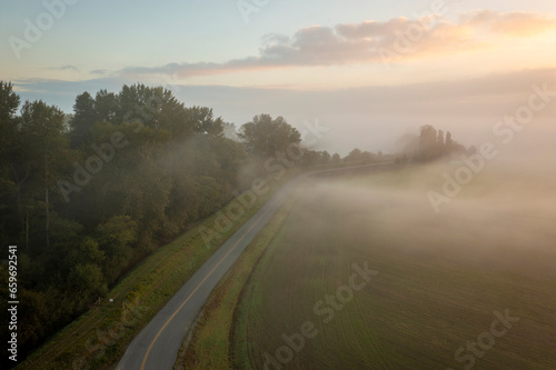 Farmland adjacent to the Skagit River shrouded in ground fog. Sunrise in the Skagit Valley during the autumnal seson means misty mornings and dramatic skies.