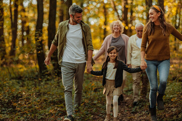 Whole Caucasian family having a walk in the forest
