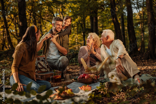 Whole Caucasian family having a picnic in the forest