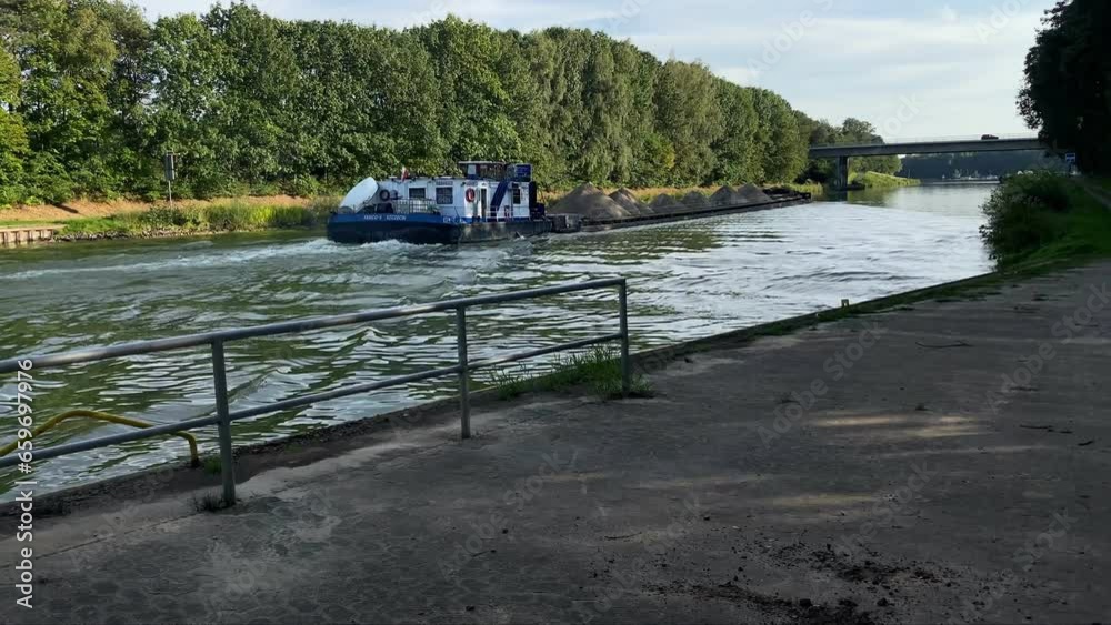 Mittellandkanal, Herstel, Germany, september 27, 2023 A cargo river barge floats along the Central German Canal Mittellandkanal, Herstel, Germany, september 27, 2023 A cargo river barge floats along the Central German Canal