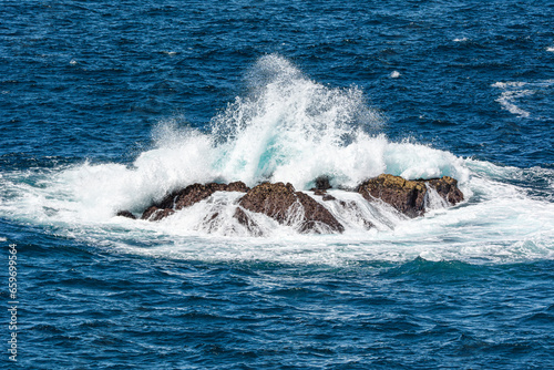 Bombora, sea waves breaking over shallow reef and rock.