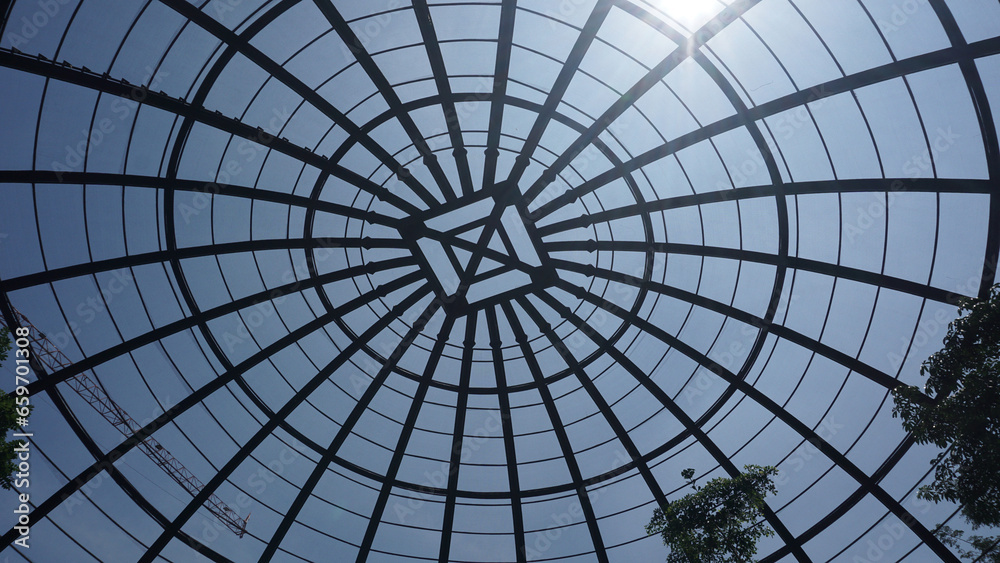 view inside a large aviary dome with curved steel in the form of dome