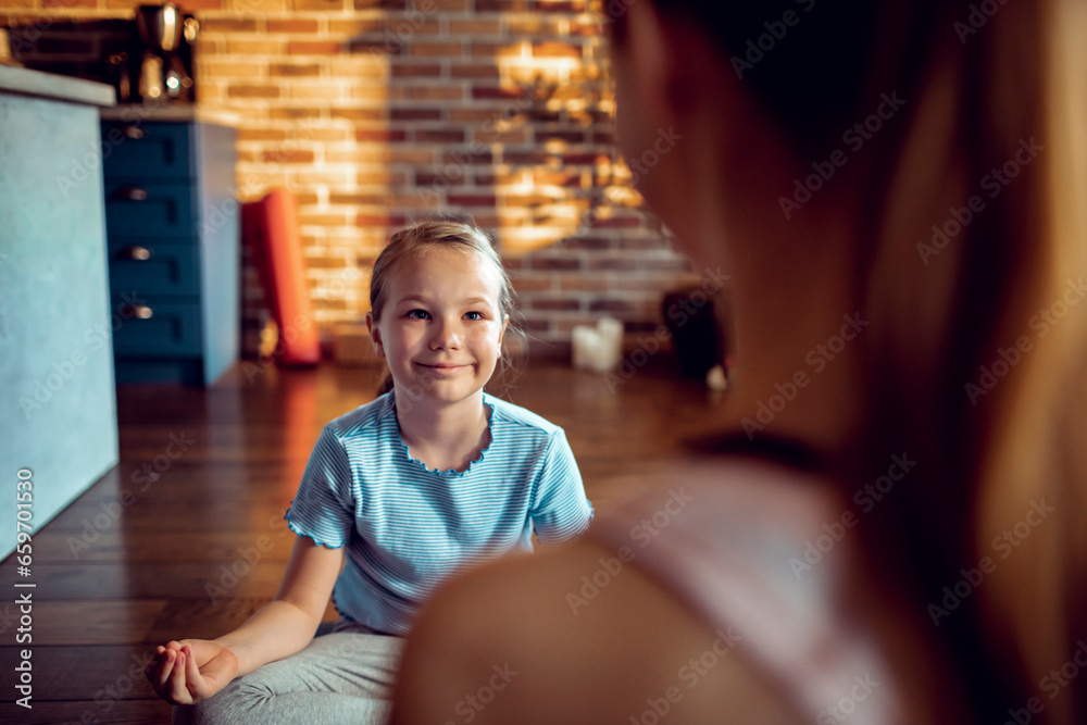 Young girl learning how to mediate with her mother at home Young girl learning how to mediate with her mother at home