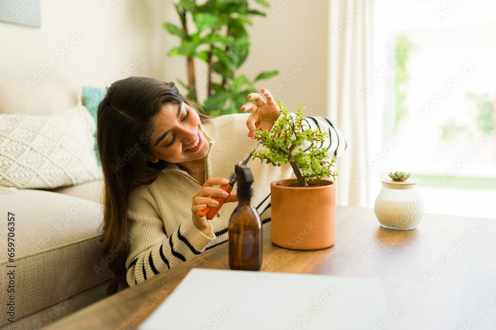 Relaxed young woman smiling doing her gardening hobby Relaxed young woman smiling doing her gardening hobby