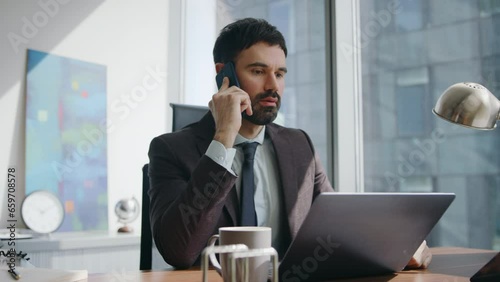 Displeased entrepreneur complaining smartphone conversation at office close up. 