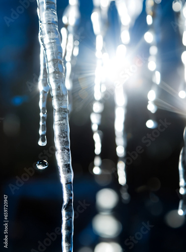 Melting icicles with dripping water and sunshine in the spring