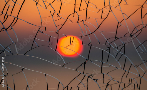 Sun through cracked glass at sunset