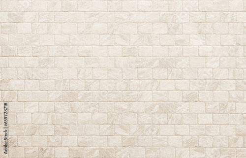 Empty background of wide cream brick wall texture. Beige old brick wall concrete or stone textured, wallpaper limestone abstract flooring. Grid uneven interior rock. Home decor design backdrop. photo