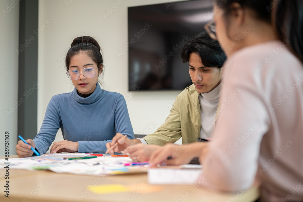 Fototapeta premium Team of young professional UX/UI designer working together in the meeting room.