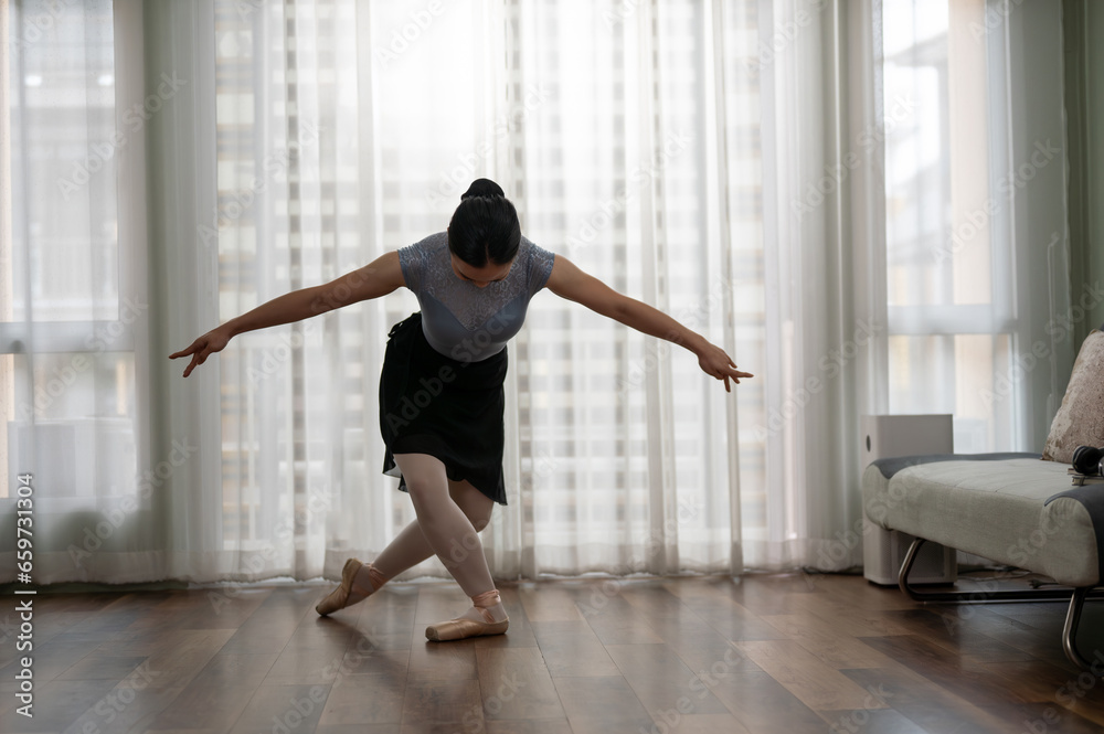 Young girl practicing ballet dancing in the living room. Young ballerina Young girl practicing ballet dancing in the living room. Young ballerina
