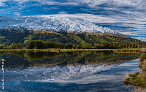 Snow mountains and reflection on lake in South Island, New Zealand